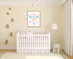 a baby's room with a white crib and lots of ladybugs on the wall