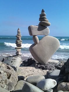 some rocks stacked on top of each other near the ocean