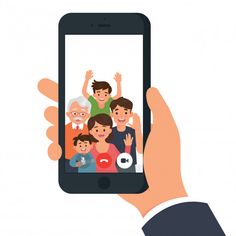 a hand holding a smart phone with an image of people on the screen in front of them