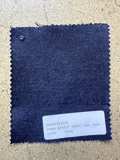 a piece of denim with a price tag on it