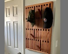 a hat rack with hats hanging on it next to a door and a white door