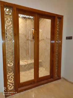 an entry door with decorative glass and wood trim