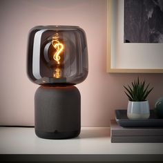 an image of a smart speaker with a light bulb in it's centerpiece