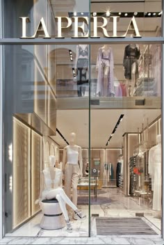 a store front with mannequins and clothes on display