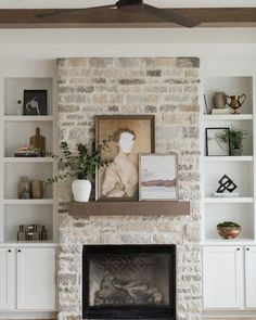 a living room filled with furniture and a fire place under a flat screen tv mounted above a stone fireplace