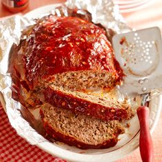 sliced meatloaf on a white plate with sauce