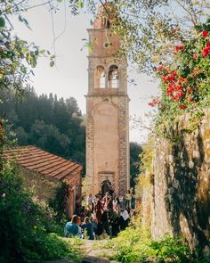 a group of people standing in front of a tall tower