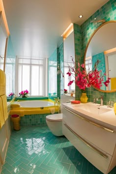 a bathroom with green tiles and yellow accents