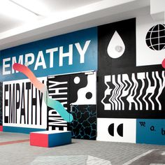 an empty room with colorful wallpaper and artwork on the walls that says empath