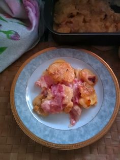 a white plate topped with food next to a baking pan