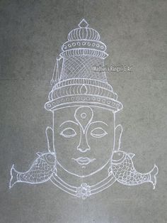 a drawing of a buddha head on the ground