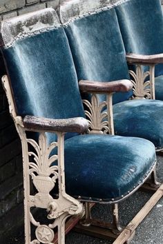 three blue velvet chairs sitting next to each other