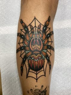 a man with a spider tattoo on his leg