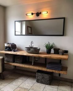 a bathroom with two sinks and a large mirror above the sink, along with wicker baskets on the floor