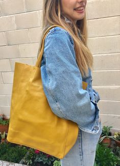 Large tote leather bag in MUSTARD YELLOW. Large shopper bag natural GENUINE leather. Large enough for books or a laptop, tablet, cosmetics bag etc. Leather shopper. The inside of the bag is not lined (although properly finished!) . We added a small leather pouch on the inner part of the bag . The bag can be closed by 2 leather straps attached to each side. Excellent quality soft but strong genuine leather. Width upper part: 41cm - 16 inch Height: 38 cm - 15 inch (CAMEL COLOR AS ON THE FIRST 3 PI Mustard Yellow Purse Outfit, Yellow Tote Bag Outfit, Modern Yellow Satchel With Large Capacity, Modern Yellow Satchel For Everyday Use, Modern Yellow Satchel For Everyday, Modern Everyday Yellow Satchel, Modern Yellow Everyday Satchel, Casual Yellow Bag With Leather Handles, Modern Yellow Satchel For Shopping