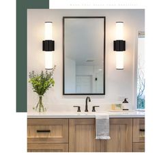 a bathroom vanity with two lights and a mirror above it