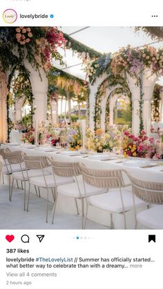 an image of a wedding venue with flowers on the ceiling and tables set up in rows