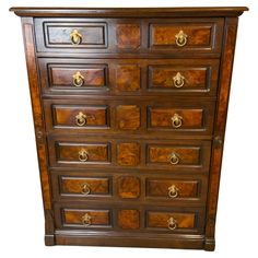 a wooden dresser with many drawers and knobs on the top drawer, against a white background