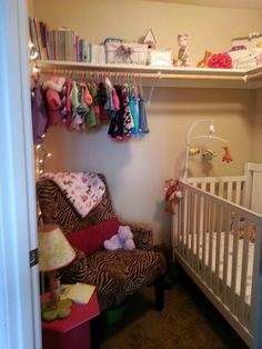 a baby's room with a crib, rocking chair and shelves filled with toys