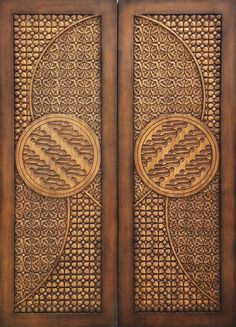 two wooden doors with intricate carvings on them