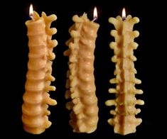 three candles that have been turned to look like human teeth and are lined up in the same row