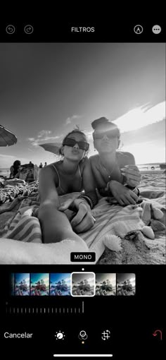 black and white photo of two people on the beach