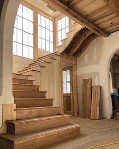 the inside of a building with wooden stairs