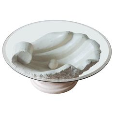 a glass plate with some white food on it's stand alone in front of a white background