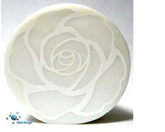 a white rose is shown in the center of a circular object on a white background