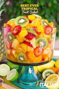 a fruit salad in a glass bowl on a table