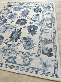 a blue and white rug is on the floor in front of a wood flooring area