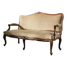 an antique style couch with wooden frame and upholstered back