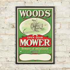 a sign on the side of a brick wall that says woods's open gear mower beware of imitationions