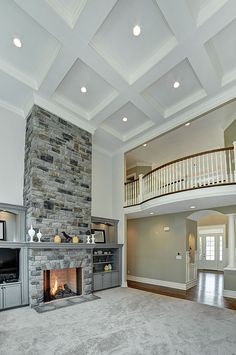 a living room with a stone fireplace and white walls