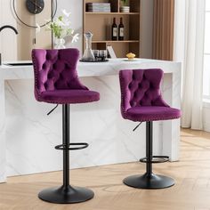 two purple velvet bar stools in front of a white marble countertop with a clock on the wall