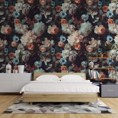 a bed sitting in front of a wall with flowers on it's side and a book shelf next to it