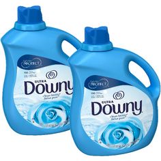 two bottles of downy liquid on a white background