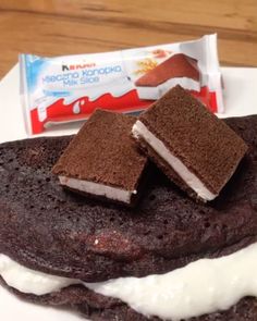 a chocolate sandwich with marshmallows on it and a bar of milk in the background