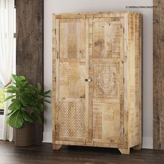 a wooden cabinet sitting next to a potted plant