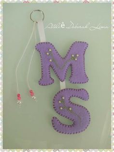 the word m is made out of felt and beads