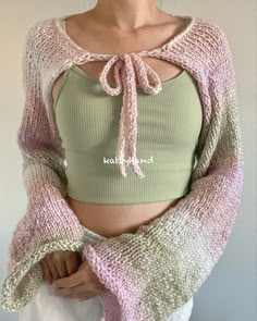 a woman wearing a crop top and sweater