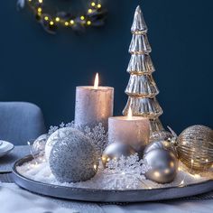 a tray with candles and ornaments on it