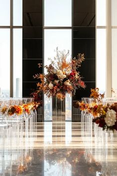 Elegant fall wedding ceremony decor featuring bold orange and yellow florals, clear acrylic chairs, and an open rooftop layout in a modern luxury hotel with city views. Rooftop Wedding Ceremony Decor, Fall Wedding Ceremony Decor, Modern Luxury Hotel, Fall Wedding Ceremony Decorations, Rooftop Wedding Ceremony, Acrylic Chairs