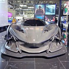 a silver sports car on display in a showroom