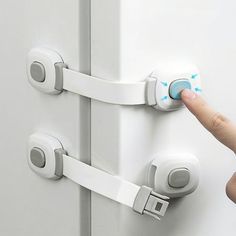 a person is pressing the button on a door handle with an electronic device attached to it