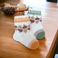 two pairs of socks sitting on top of a wooden table