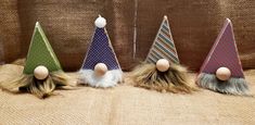 three small gnome hats with long hair on them