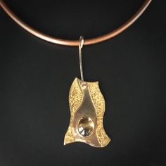 "Striking pendant features 14K & 22K textured gold set with one oval 8 x 10mm Citrine cabochon.  Suspended from a copper-color 16\" rubber neck cord with 14K yg hook clasp.  Total length of pendant including 14k wire attachment is approx. 2 3/8\"." Silver Necklace Designs, Abstract Pendant, Abstract Jewelry, Mixed Metal Jewelry, Precious Metal Clay, Hook Clasp, Metal Clay, Brass Pendant, Precious Metal