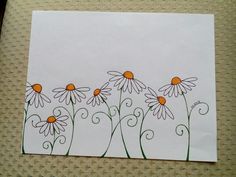 a drawing of daisies on a white paper