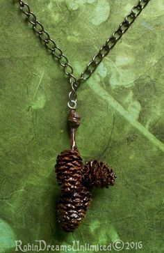 "This necklace is 18 1/4\" round the neck with a pendent that drops 2 1/4\" below the chain.  This necklace weighs 7.56 grams. The pendent is a group of three alder pinecones hanging from a 3.5 mm by 5.5 mm gunmetal curb chain which is clasped with a lobster clasp 6 mm by 12 mm. The lobster clasp can attach anywhere along the chain which ends in a 5 mm jump ring, to adjust to any length needed.  I gathered the alder pinecones from the Arcata area of California over the year 2015.  They are natur Pinecone Necklace, Oval Earring, Curb Chain, Jump Rings, Pine Cones, Lobster Clasp, Selling On Etsy, Jewelry Necklace Pendant, Necklace Lengths